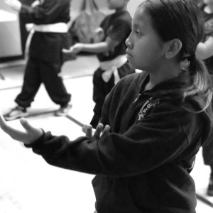 A CHILD PRACTICING MARTIAL ARTS